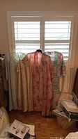 Five nightwear garments hanging in front of window
