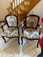 Front view of both armchairs showing upholstery, frames and overall design