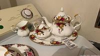 Teapot, creamer, sugar bowl, platter grouped together