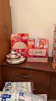 Boxes of Royal Albert Old Country Roses place settings and loose stacked pieces