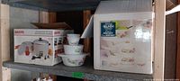 Both boxed items on shelf: Sanyo rice cooker box and Belinda bowl set box with some bowls visible