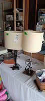 Both table lamps together showing different base finishes and identical drum shades