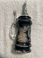 Side view of crystal stein showing lid, handle, and black crystal body