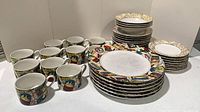 Full set stacked showing cups, plates, bowls