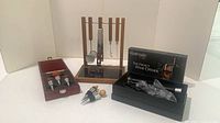 Full lot view showing bar rack with tools, boxed wine stopper set, two loose stoppers, and Perfect Wine Opener kit