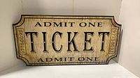 Front of Ticket sign showing text and distressed finish