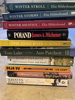 Stack of ten paperback books showing spines and titles