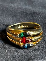 Ring angled to show triple split shank and three colored stones