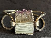 Front view of silver bracelet displaying amethyst geode slice