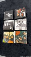 Front view of six Beatles Parlophone CDs arranged 2x3