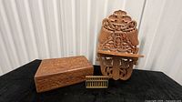 Wall shelf, carved box, and abacus grouped together