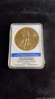 Front view of sealed 1907 Saint-Gaudens Double Eagle replica coin in holder showing label and obverse design