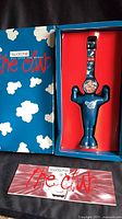 Closed box showing Swatch Club clouds design with watch in stand