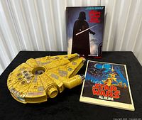 Millennium Falcon toy with two books displayed