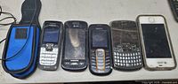 lineup of five phones and holster on table