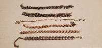 All six bracelets laid out in a row for size and style comparison