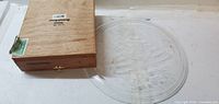 Glass plate and closed cigar box side by side