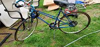 Left side full view of blue Peugeot bicycle on grass