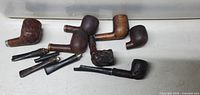 Overview of six pipe bowls and loose stems