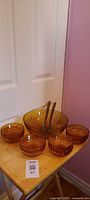 Complete 7-piece amber pressed glass salad set displayed