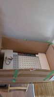 Grow light panel inside cardboard box with foam inserts