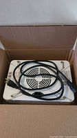 Grow light in box with coiled power cord on top