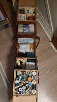 Full view of multi-tier sewing box opened showing all contents