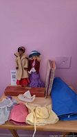 Overall lot showing doll, second doll figure, domino box, children’s books, loose doll clothes
