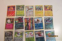 Overall view of 15 Pokémon cards in three rows
