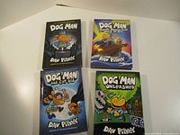 Group shot of four Dog Man hardcovers