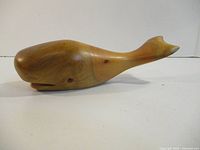 Left side view of carved driftwood sperm whale