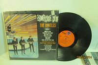 Front cover alongside vinyl record