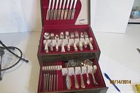 Full view of open two-tier cutlery chest showing majority of 118 pieces