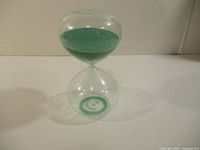 Full view of glass hourglass standing upright