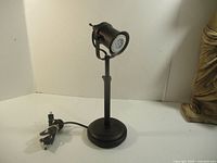 Full view of black metal LED table spotlight with cord