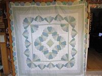 Full view of quilt hung flat showing overall pattern and size
