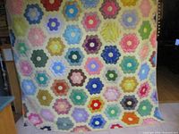 Full view of multicolour hexagon flower patchwork quilt