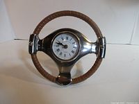Front view of steering wheel clock showing dial and wrapped rim