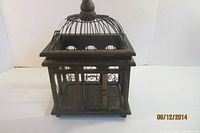 Overall view of wooden bird cage front and side