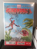 Front cover of Deadpool #1 comic book in bag and board