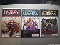Front covers of all three signed comics