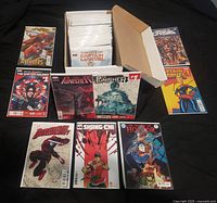 Overview showing box of bagged comics with nine first issues displayed