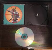 Open jewel case showing interior artwork and empty disc tray