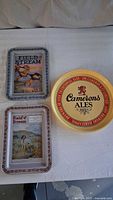 Three metal trays, Camerons Ales round and two Field & Stream rectangular
