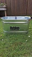 Full view of Behlen Country galvanized stock tank showing branding and overall condition