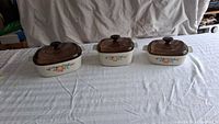 Three CorningWare Abundance casseroles with lids
