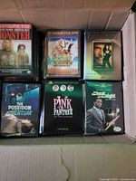 Box of DVDs showing Monster, Entertaining Soldier, The Pink Panther, The Poseidon Adventure, In the Heat of the Night