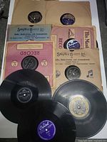 Group shot showing nine 78 rpm records and assorted sleeves