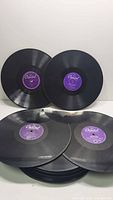 Group of Capitol purple-label 78s with additional discs beneath
