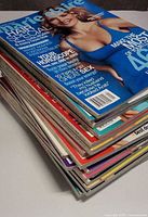 Stack of Marie Claire magazines showing thickness and colorful spines